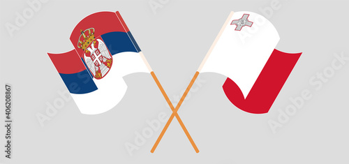 Crossed and waving flags of Serbia and Malta