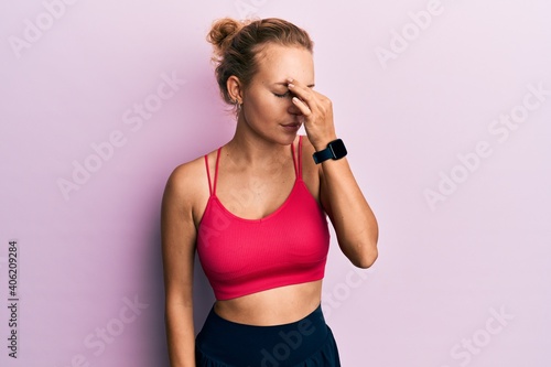 Beautiful caucasian woman wearing sportswear tired rubbing nose and eyes feeling fatigue and headache. stress and frustration concept.