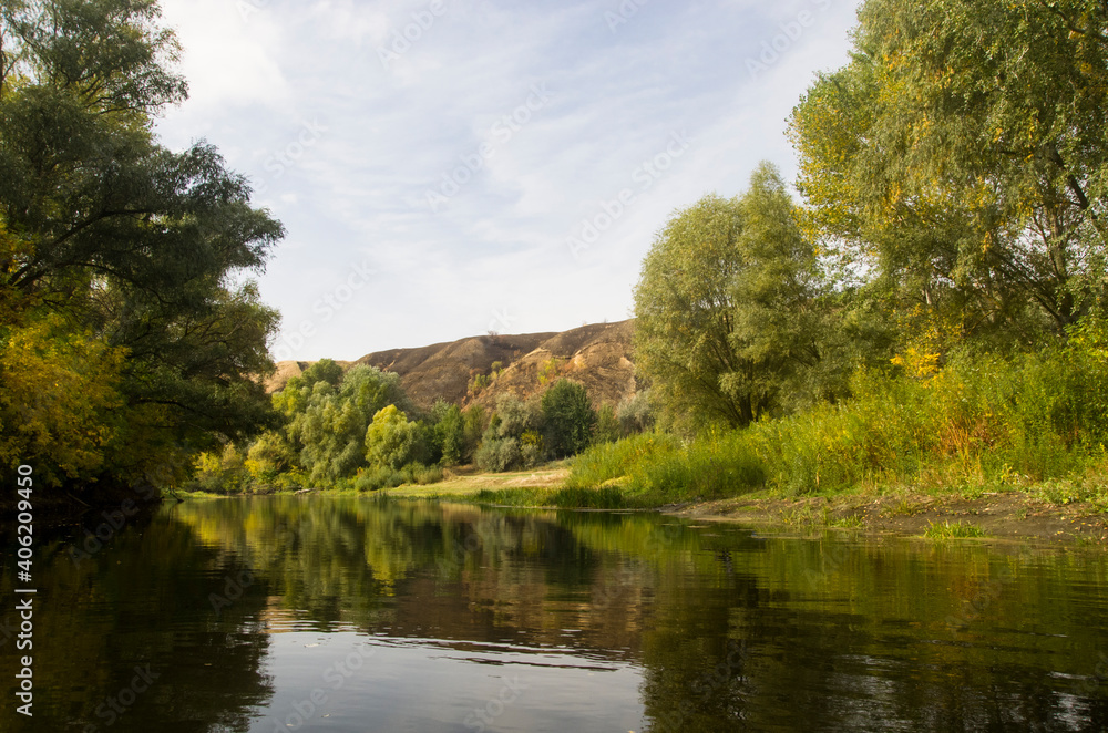 Autumn landscape of the river with hills on the bank