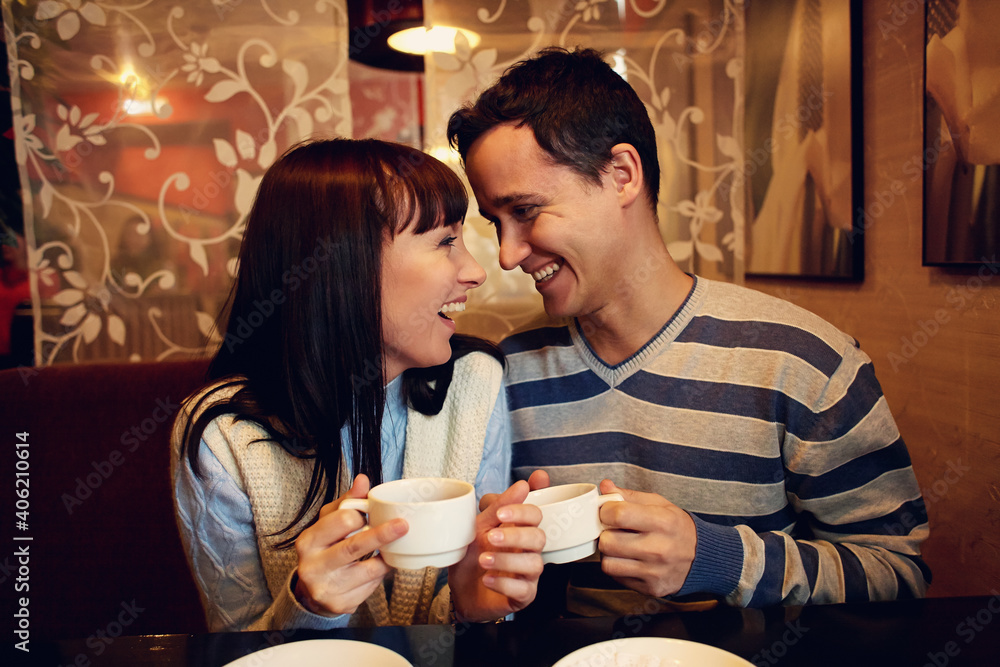 man and woman sitting in a cafe on a date. young couple in love