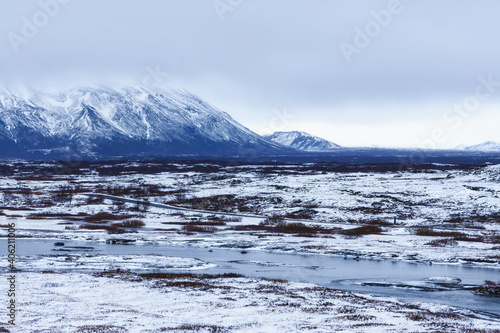 Selective focus landscape in Iceland with mountains, rivers, trees and snow