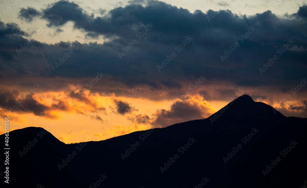 Stunning view of the silhouette of a mountain range during a dramatic sunset.