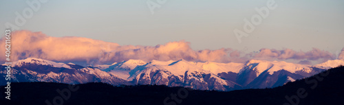 Stunning view of a snow capped mountain range during a beautiful sunset. © Travel Wild