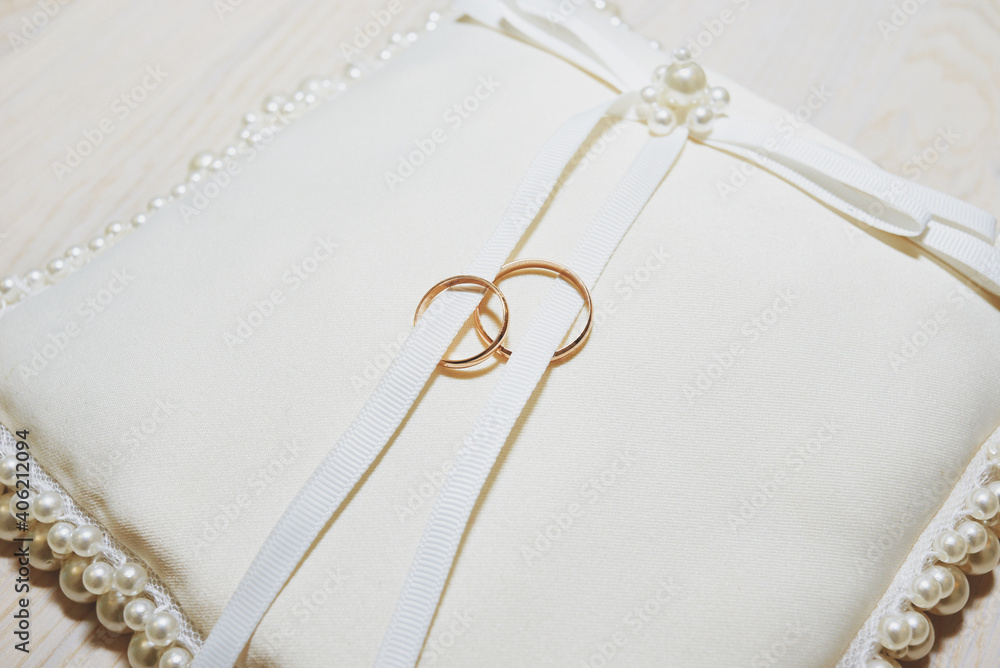 wedding rings on a white decorated pillow. wedding ceremony wedding rings on a white decorated pillow. wedding ceremony