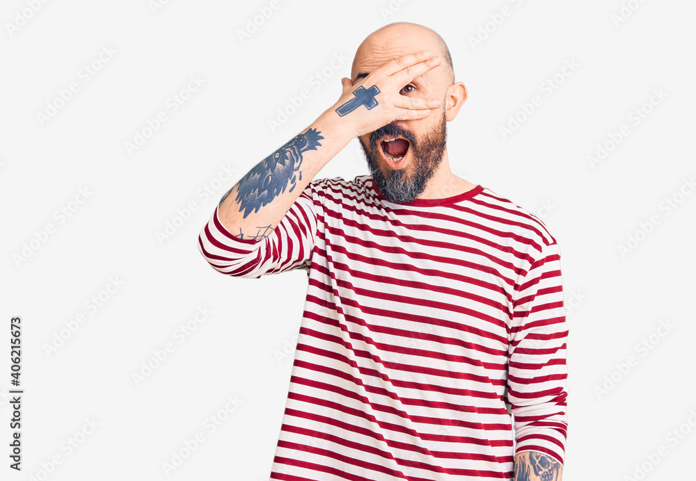 Young handsome man wearing casual clothes peeking in shock covering face and eyes with hand, looking through fingers with embarrassed expression. Young handsome man wearing casual clothes peeking in shock covering face and eyes with hand, looking through fingers with embarrassed expression.