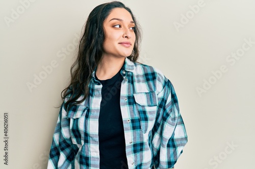 Obraz na plátně Beautiful middle eastern woman wearing casual clothes looking to side, relax profile pose with natural face and confident smile