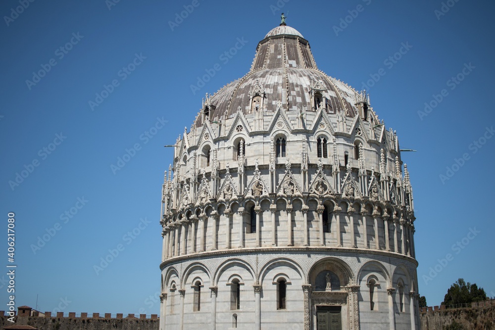 The Pisa Baptistery with bright blue sky at sunny day