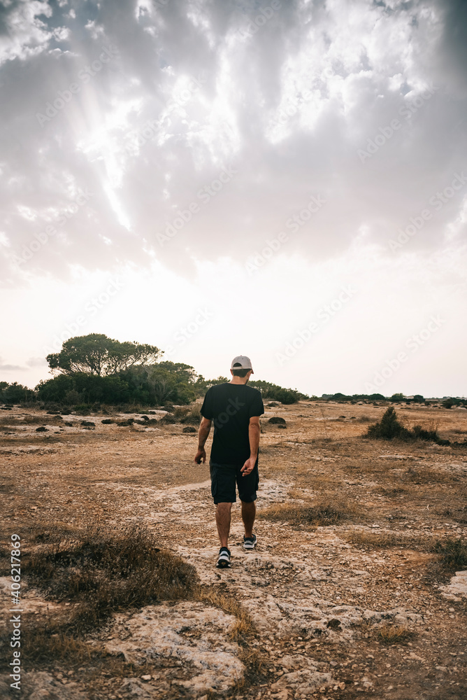 Young man walking in the countryside. Young man walking in the countryside.