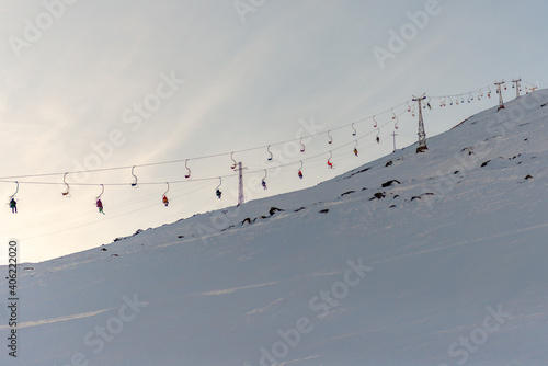 The old chair lift on mount Cheget. Skiers climb the mountain