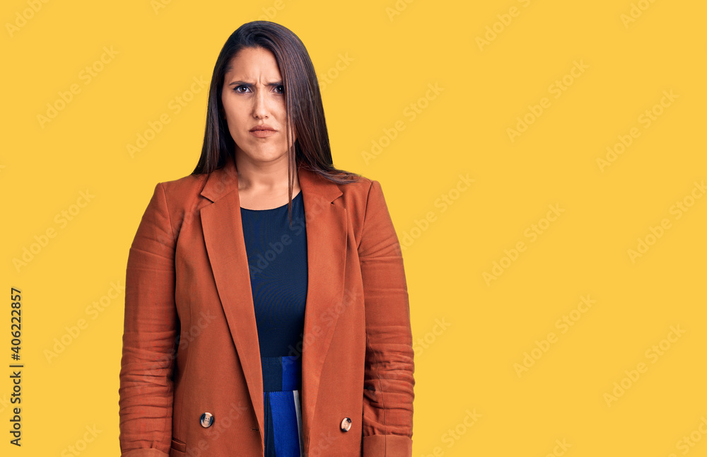 Young beautiful brunette woman wearing elegant clothes skeptic and nervous, frowning upset because of problem. negative person. Young beautiful brunette woman wearing elegant clothes skeptic and nervous, frowning upset because of problem. negative person.