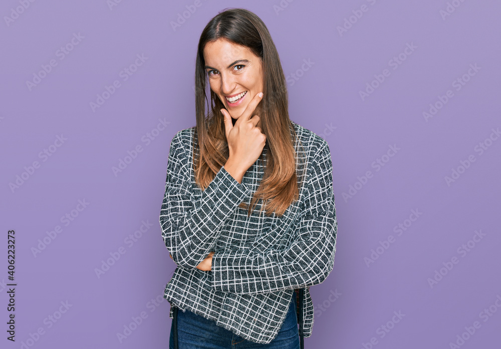 Young beautiful woman wearing casual clothes looking confident at the camera smiling with crossed arms and hand raised on chin. thinking positive. Young beautiful woman wearing casual clothes looking confident at the camera smiling with crossed arms and hand raised on chin. thinking positive.