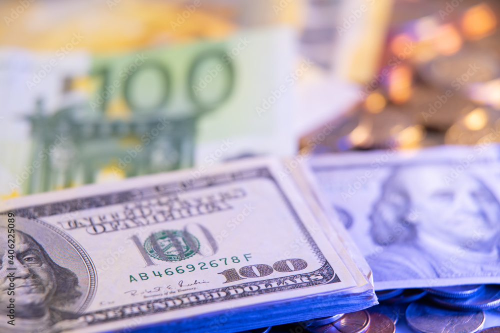 100 Euro Bills and Dollar Bills on top of Euro Coins. European and USA Currencies. Exchange rate Dollar Euro 100 Euro Bills and Dollar Bills on top of Euro Coins. European and USA Currencies. Exchange rate Dollar Euro