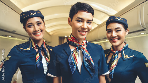 Fotografering Group of cabin crew or air hostess in airplane