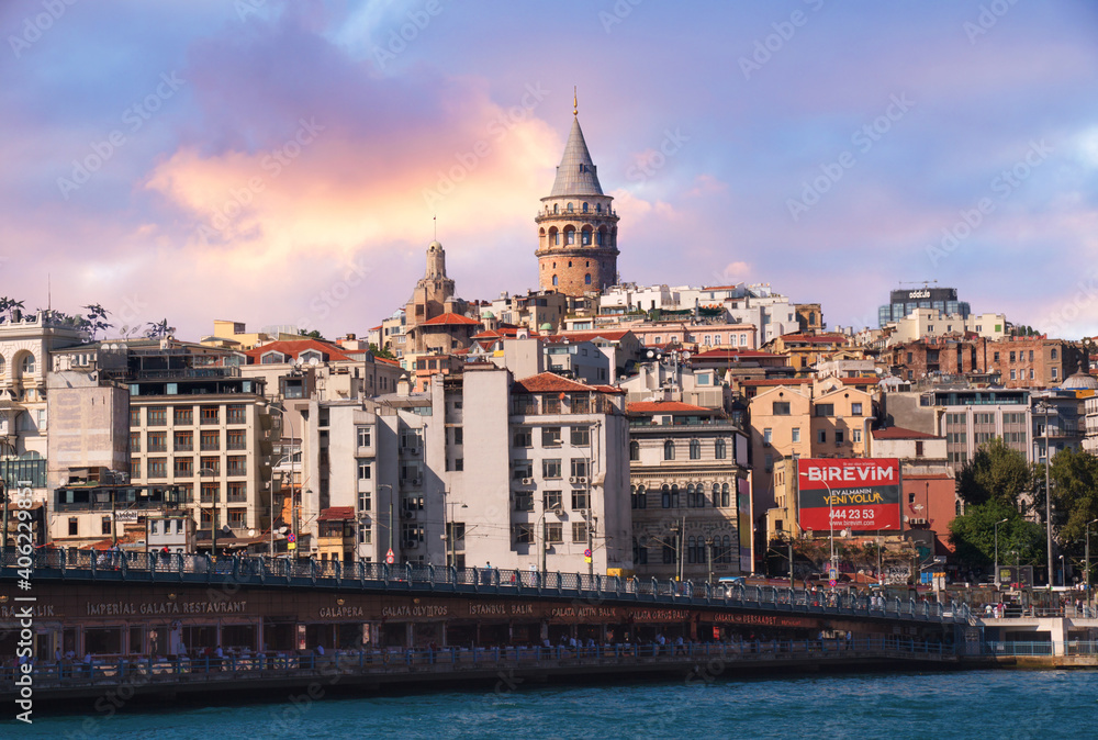 ISTANBUL, TURKEY - 09 07 2020: Galata Bridge, Galata Tower, Karakoy district with magnificent sunset clouds seen across Golden Horn in Istanbul, Turkey