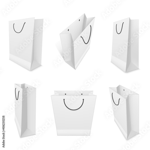 Shopping paper bags realistic mockups set. White blank packaging with rope handles templates.