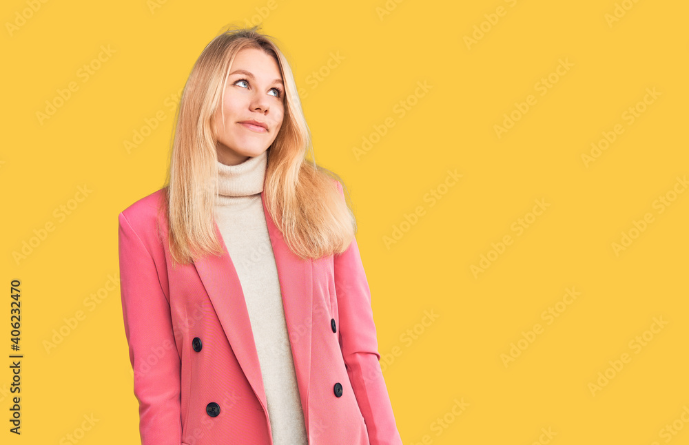 Young beautiful blonde woman wearing elegant clothes smiling looking to the side and staring away thinking. Young beautiful blonde woman wearing elegant clothes smiling looking to the side and staring away thinking.