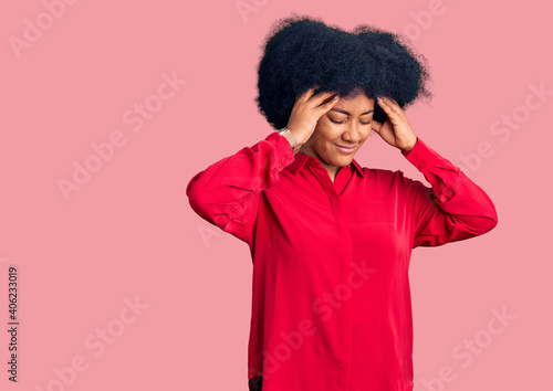 Young african american girl wearing casual clothes suffering from headache desperate and stressed because pain and migraine. hands on head. © Krakenimages.com
