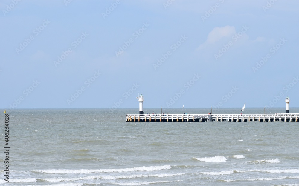 Lighthouse and pier with people Lighthouse and pier with people