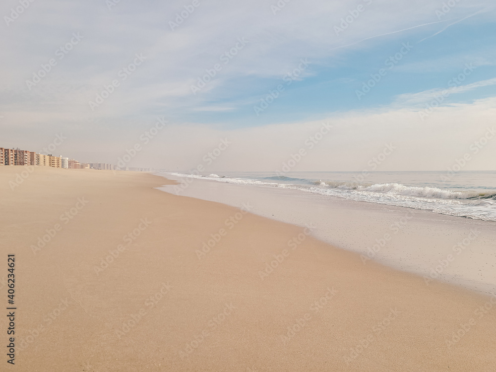 A minimal beach shore. Soft wave of the Ocean on the sandy beach. Rockaway Beach, New York. 