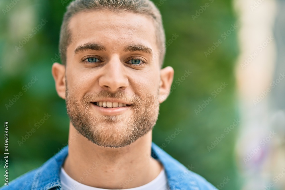 Young caucasian man smiling happy standing at the park. Young caucasian man smiling happy standing at the park.