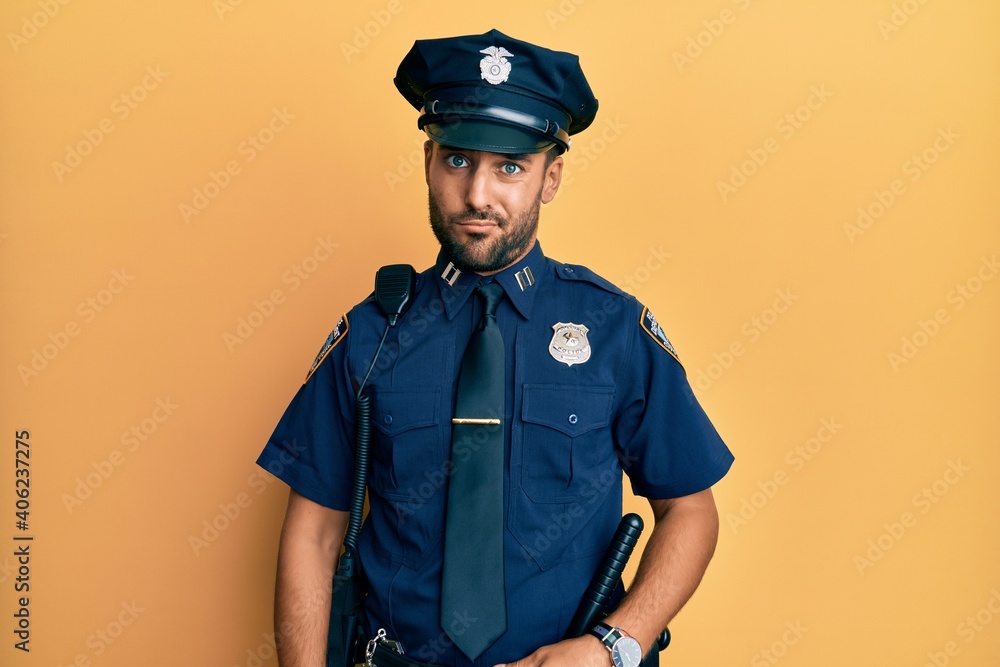 Handsome hispanic man wearing police uniform skeptic and nervous, frowning upset because of problem. negative person. Handsome hispanic man wearing police uniform skeptic and nervous, frowning upset because of problem. negative person.