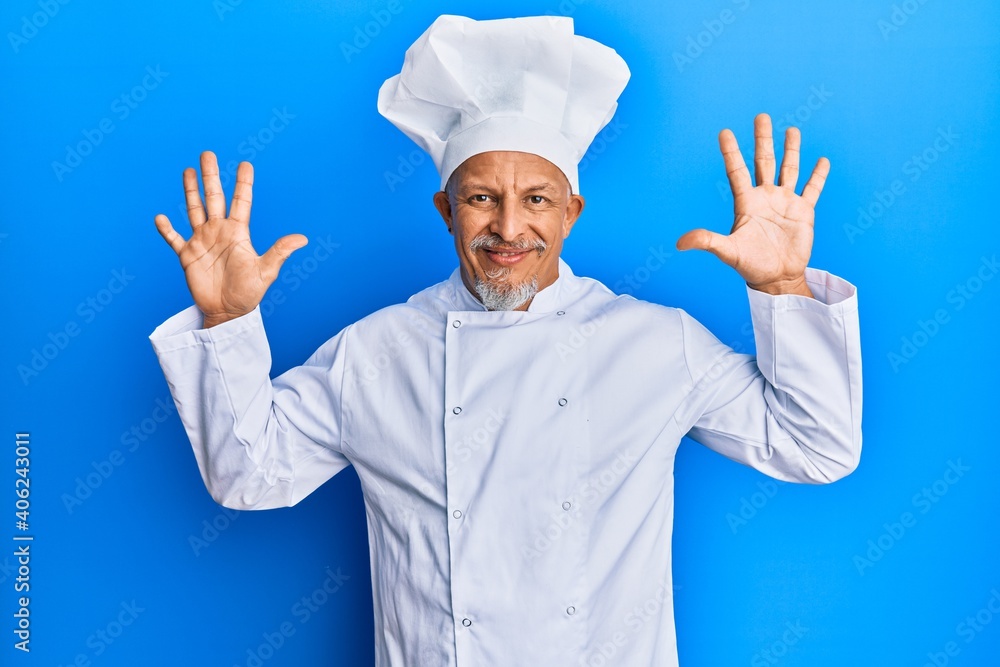 Middle age grey-haired man wearing professional cook uniform and hat showing and pointing up with fingers number ten while smiling confident and happy. Middle age grey-haired man wearing professional cook uniform and hat showing and pointing up with fingers number ten while smiling confident and happy.