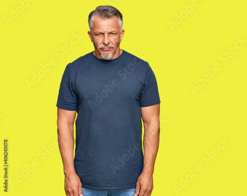 Middle age grey-haired man wearing casual clothes skeptic and nervous, frowning upset because of problem. negative person.