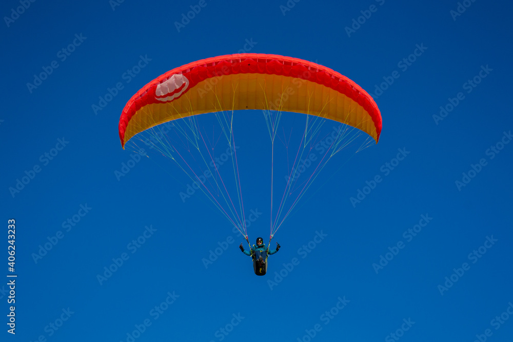 A beautiful view of a paraglide flying gliding on a clear blue sky at the golden hour with a nice wind windy breeze on a sunny day A beautiful view of a paraglide flying gliding on a clear blue sky at the golden hour with a nice wind windy breeze on a sunny day