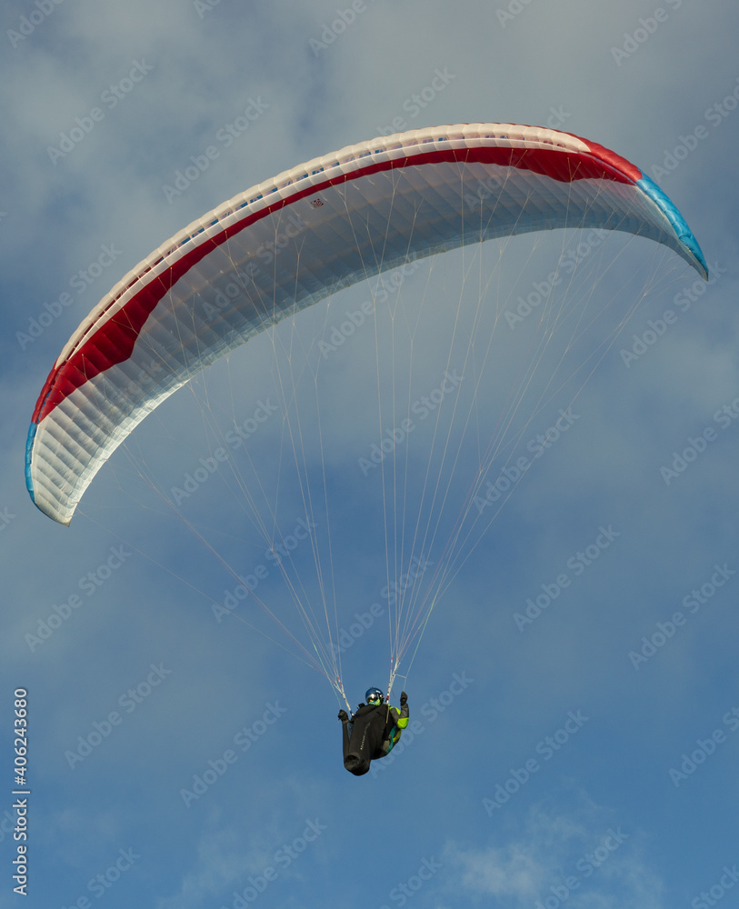A beautiful view of a paraglide flying gliding on a clear blue sky at the golden hour with a nice wind windy breeze on a sunny day A beautiful view of a paraglide flying gliding on a clear blue sky at the golden hour with a nice wind windy breeze on a sunny day