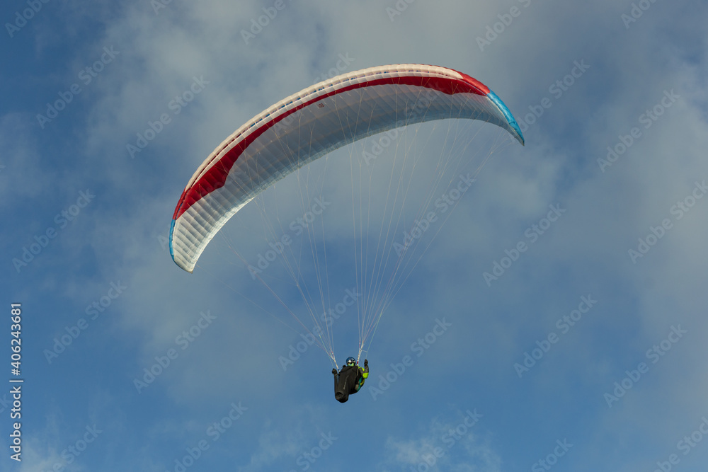 A beautiful view of a paraglide flying gliding on a clear blue sky at the golden hour with a nice wind windy breeze on a sunny day A beautiful view of a paraglide flying gliding on a clear blue sky at the golden hour with a nice wind windy breeze on a sunny day
