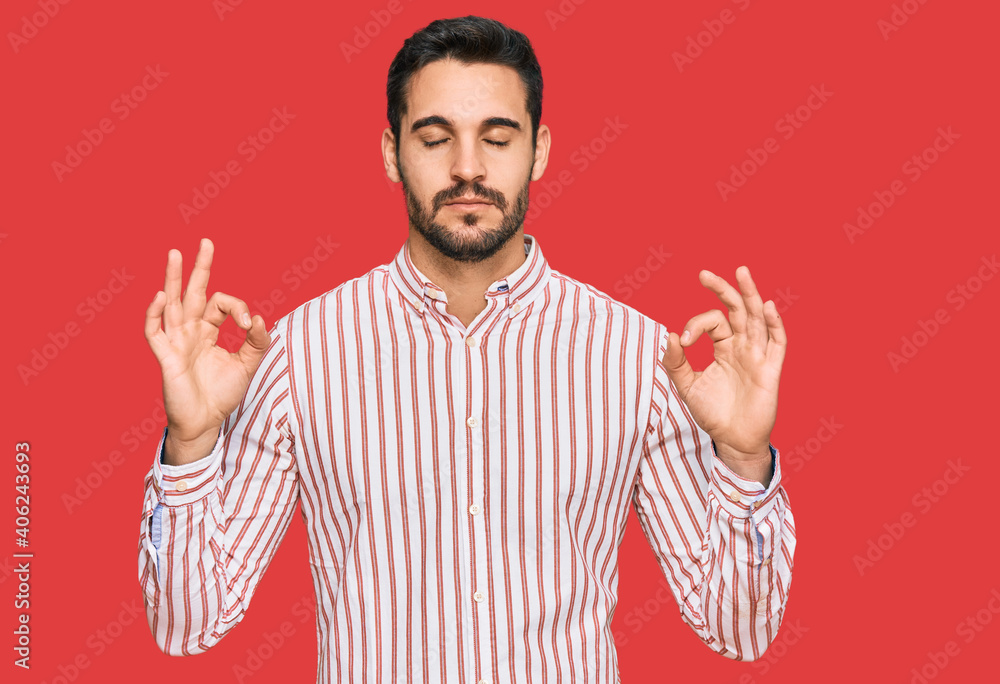Fototapeta premium Young hispanic man wearing business shirt relax and smiling with eyes closed doing meditation gesture with fingers. yoga concept.