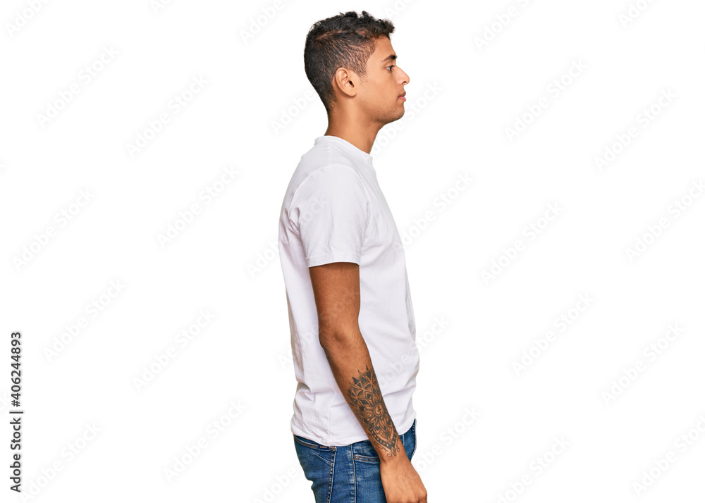 Young handsome african american man wearing casual white tshirt looking to side, relax profile pose with natural face with confident smile. Young handsome african american man wearing casual white tshirt looking to side, relax profile pose with natural face with confident smile.