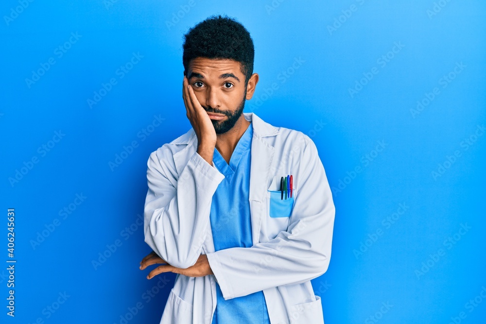 Handsome hispanic man with beard wearing doctor uniform thinking looking tired and bored with depression problems with crossed arms. Handsome hispanic man with beard wearing doctor uniform thinking looking tired and bored with depression problems with crossed arms.