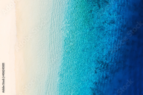 Waves as a background from top view. Azure water background from drone. Summer seascape from air. Gili Meno island, Indonesia. Travel and vacation image
