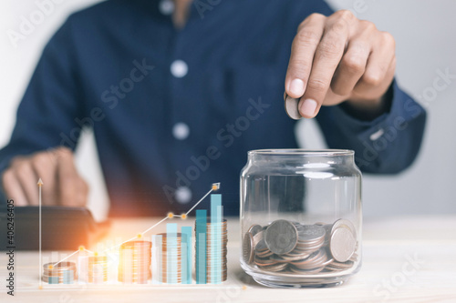 businessman holding coins putting in glass. concept saving money for finance accounting to arrange coins into growing graphs concept.
