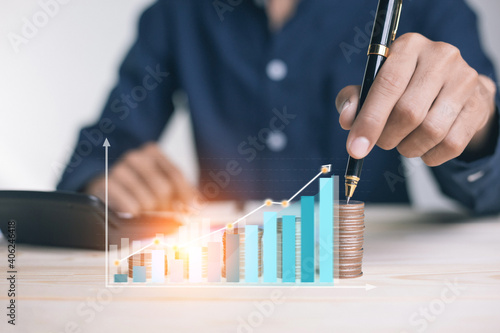 businessman holding coins putting in glass. concept saving money for finance accounting to arrange coins into growing graphs concept.