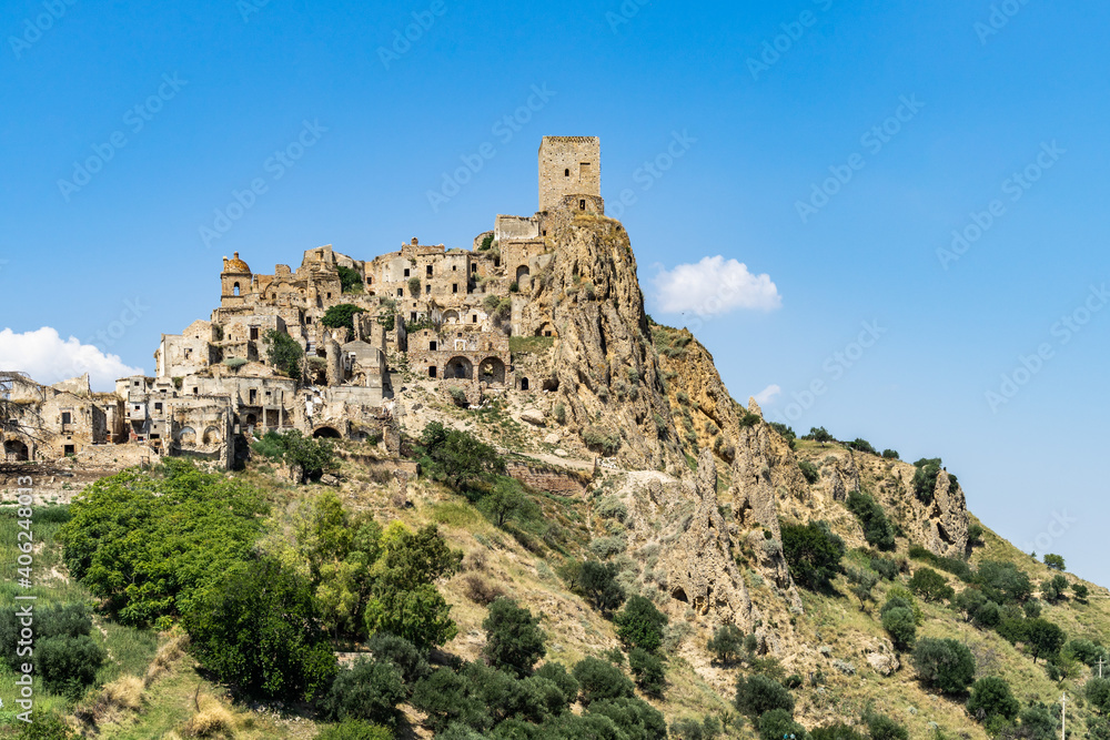 View of Craco, a ghost town in Basilicata region abandoned due to natural disasters and now popular tourist destination, Italy