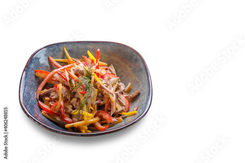 A bowl with sliced bell peppers, meat in sauce and herbs on a white isolated background.