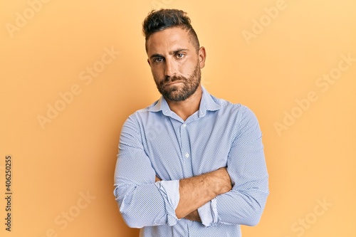 Handsome man with beard wearing casual clothes skeptic and nervous, disapproving expression on face with crossed arms. negative person.