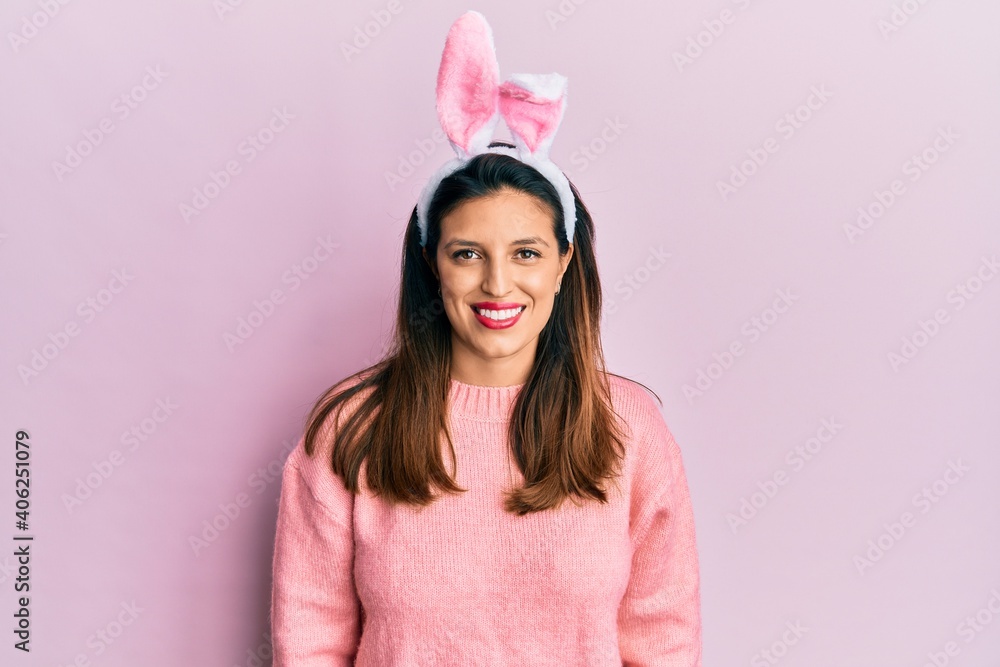 Beautiful hispanic woman wearing cute easter bunny ears with a happy and cool smile on face. lucky person. Beautiful hispanic woman wearing cute easter bunny ears with a happy and cool smile on face. lucky person.