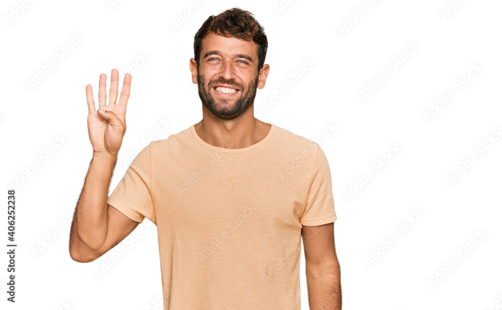 Handsome young man with beard wearing casual tshirt showing and pointing up with fingers number four while smiling confident and happy. Handsome young man with beard wearing casual tshirt showing and pointing up with fingers number four while smiling confident and happy.