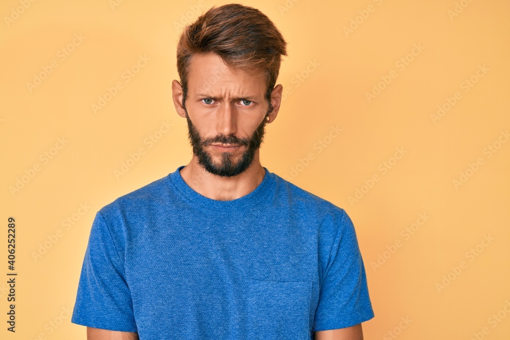 Handsome caucasian man with beard wearing casual clothes skeptic and nervous, frowning upset because of problem. negative person. Handsome caucasian man with beard wearing casual clothes skeptic and nervous, frowning upset because of problem. negative person.