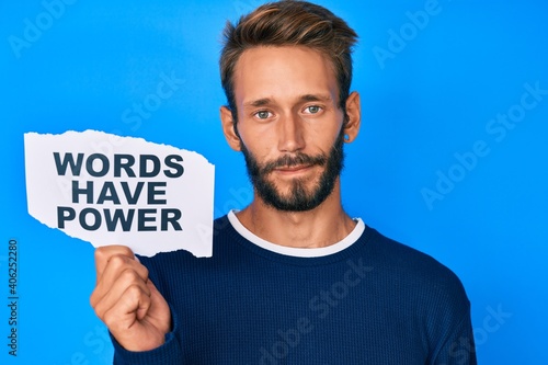 Fotografie Handsome caucasian man with beard showing words have power banner thinking attit