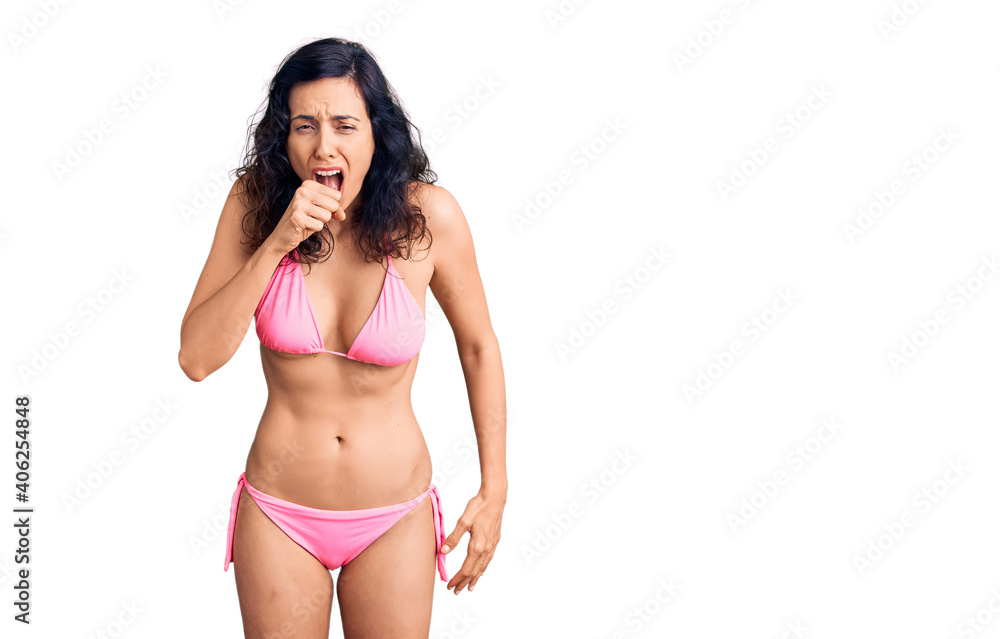 Naklejka premium Young beautiful hispanic woman wearing bikini feeling unwell and coughing as symptom for cold or bronchitis. health care concept.