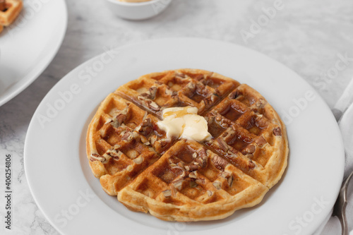 Close-up of Homemade Pecan Waffles with Butter and Syrup