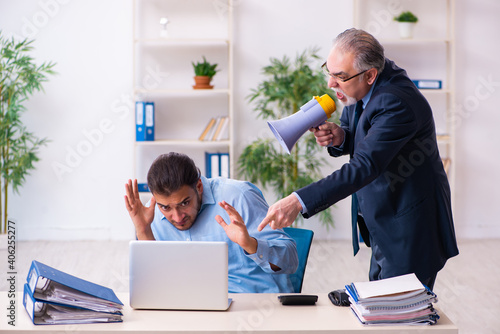 Old boss and his young assistant in the office