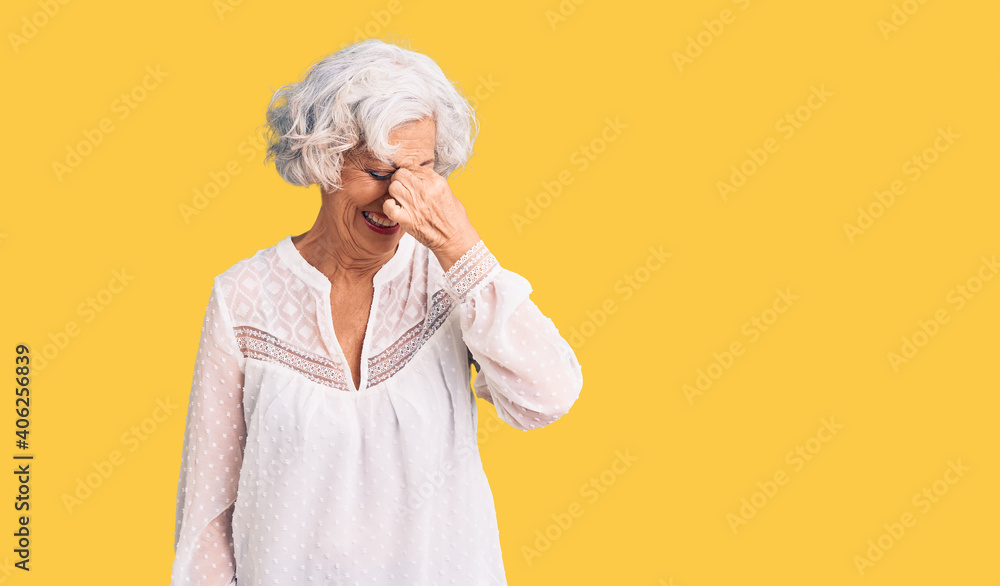 Senior grey-haired woman wearing casual clothes tired rubbing nose and eyes feeling fatigue and headache. stress and frustration concept. Senior grey-haired woman wearing casual clothes tired rubbing nose and eyes feeling fatigue and headache. stress and frustration concept.