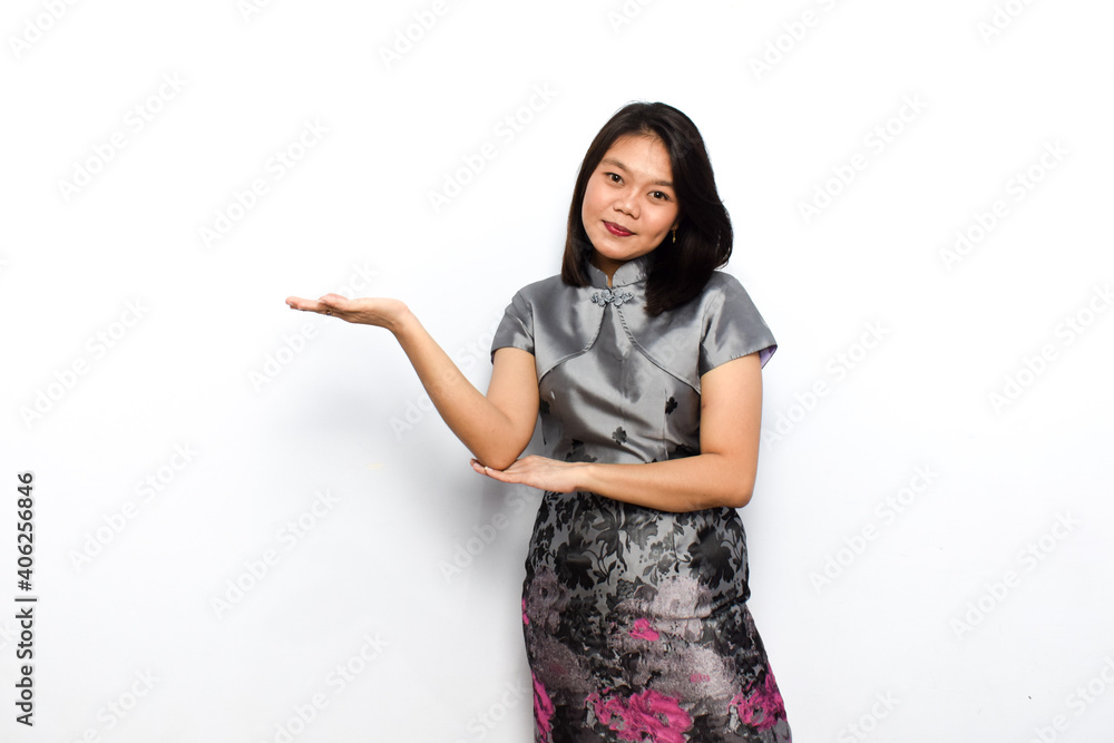 Asian Woman Dress Traditional Cheongsam, Presenting with palm and Celebrate Chinese New Year Concept Isolated on White Background Asian Woman Dress Traditional Cheongsam, Presenting with palm and Celebrate Chinese New Year Concept Isolated on White Background