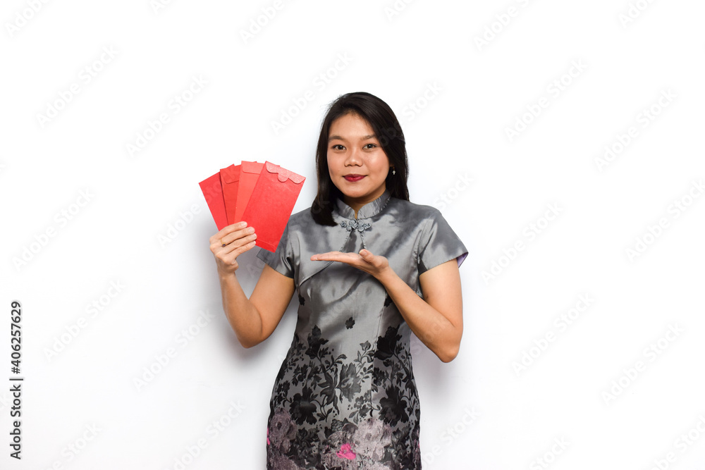 Asian Woman Dress Traditional Cheongsam, Presenting and Hold Red Envelope (Angpau) Isolated on White Background Asian Woman Dress Traditional Cheongsam, Presenting and Hold Red Envelope (Angpau) Isolated on White Background