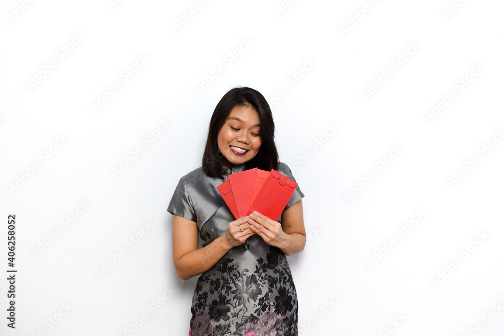 Asian Woman Using Traditional Cheongsam And Hold Red Envelope (Angpau) Isolated on White Background Asian Woman Using Traditional Cheongsam And Hold Red Envelope (Angpau) Isolated on White Background